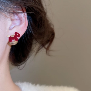 Detail view of red flocked pony earring with champagne pearl stud on model's ear