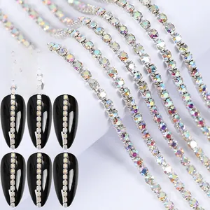 Macro shot of colorful AB rhinestone nail art chain with long black manicure samples