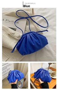 Detail of electric blue pleated cloud bag with soft leather texture and slim shoulder strap