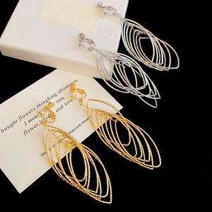 Detail of gold and silver hollow leaf clip-on earrings with textured matte finish