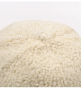 Macro detail of plush cream sherpa fleece fabric showing fluffy texture on baseball cap
