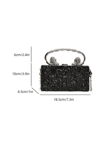 Detail view of black acrylic clutch with silver lion head handle and dimension markings