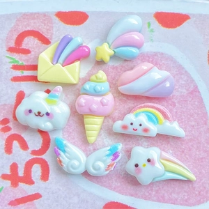 Flat lay of colorful resin charms in pastel shapes of clouds rainbows and ice cream