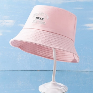 Close-up of pink cotton bucket hat with white Brooklyn New York embroidery detail