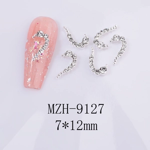 Detailed view of silver heart nail charms with rhinestones and 7x12mm dimensions