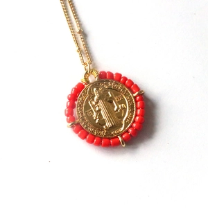 Golden beaded coin necklace featuring a colorful Virgin Mary religious Saint Benedict medal