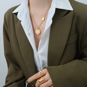 French style 18k gold plated titanium necklace with coin pendant and spliced chain on model