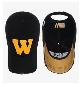 Detail of distressed embroidery and inner stitching on the vintage black baseball cap