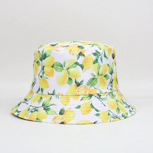 Detail shot of white bucket hat featuring a vibrant yellow lemon and green leaf pattern