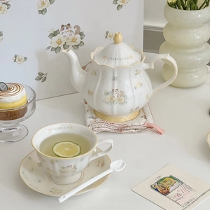 Detailed view of camellia and ragdoll cat ceramic teapot set with vintage gold rimming