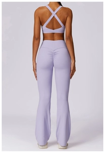 Detail view of purple yoga set featuring cross back bra and scrunch butt flared leggings