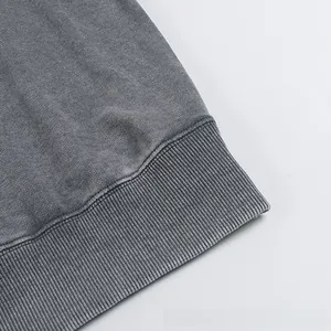 Detailed close-up of ribbed cuffs on a heavy washed grey oversized cotton sweatshirt