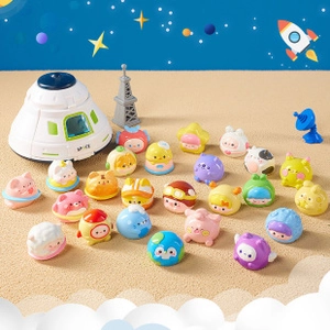 Detailed top-view of a space toy set with characters, a capsule, and an Eiffel Tower model