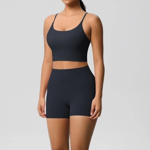 Detail of black yoga set featuring slim fit tank top with thin straps and high waist shorts