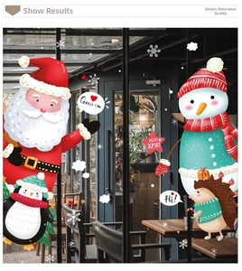 Detailed Christmas window decals showing Santa, snowmen and penguins on glass shop door