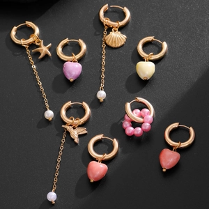 Golden hoop earrings set with ceramic hearts, starfish, birds and pearl chains pendants