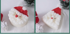 Detail of Santa Claus handmade scented candles with festive cream textures and pine decor