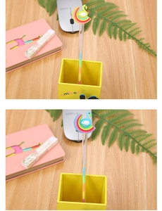 Detail of creative multi-color pen with soft swan and rainbow charms in a yellow holder
