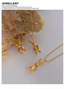 Detail view of 18K gold plated mechanical rabbit pendant necklace with LUCK engraving