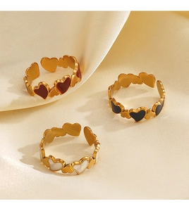 Detail of 18K gold plated heart rings with red black and white enamel on silk fabric