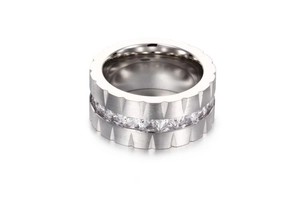 Detail of silver titanium steel wide ring with frosted finish and square zircon inlay