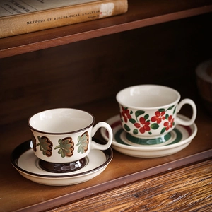 Detail view of vintage hand-painted ceramic coffee cup sets with floral and leaf patterns
