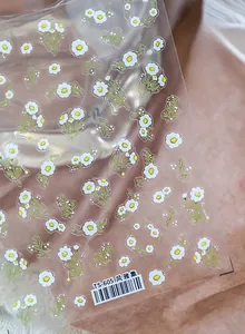 Detailed close-up of TS-605 white daisy nail art stickers with delicate green leaves