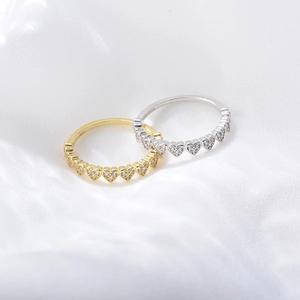Elegant S925 sterling silver heart-shaped zircon rings on smooth white silk fabric
