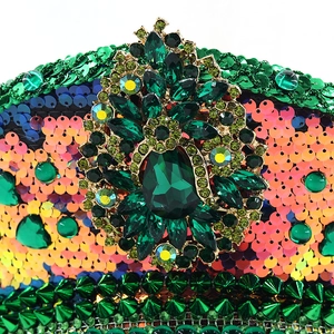 Macro detail of luxury festival hat featuring green gemstone badge and metallic spikes