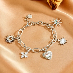 Macro shot of silver stainless steel charm bracelet featuring star and heart pendants