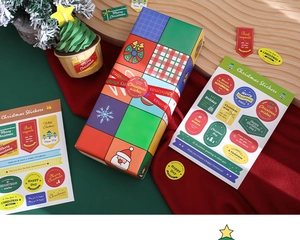 Close-up of decorative Christmas stickers applied to gift boxes and cupcake wrappers