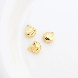 Detailed view of three 14k gold plated shell pendants for DIY jewelry making