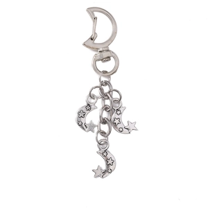 Vintage silver alloy star and moon keychain with celestial charms on white background