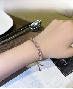 Detail of rose gold tennis bracelet with baguette-cut zircons and adjustable sliding clasp