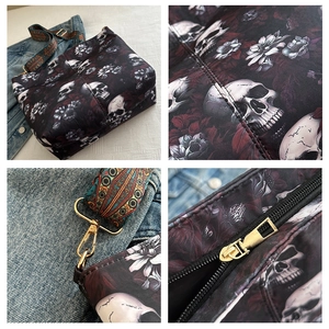 Detail view of gothic skull and floral print tote bag with woven strap and gold hardware