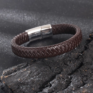 Detail view of deep brown woven leather strap with silver magnetic stainless steel clasp