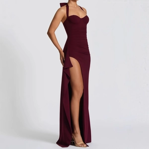 Detail of burgundy evening gown with halter neck and side high slit with ruffles