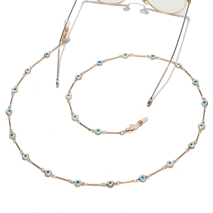 Golden eyewear chain with evil eye charms and silicone loops on white background