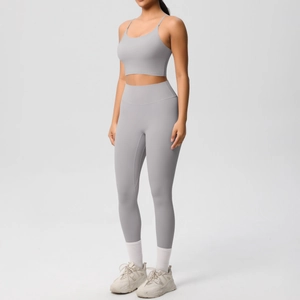 Detail of high-waisted seamless grey yoga leggings and matching crop top sports set
