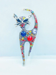 Macro shot of silver cat brooch with vibrant multicolored rhinestones and sparkling gems