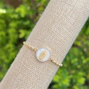 Detail of 18K gold-plated Virgin Mary shell pendant with sparkling cubic zirconia