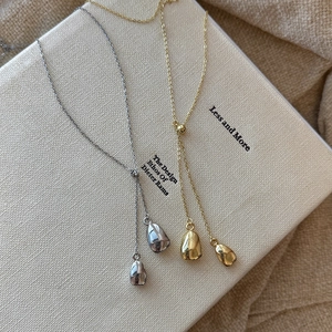 Minimalist 18k gold and silver plated Y-shaped pendant necklaces on a neutral background
