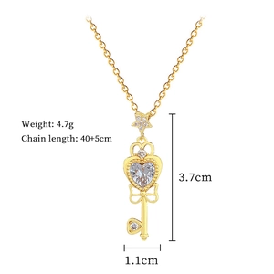 Detailed view of bow key pendant with heart stone and 40+5cm chain measurements