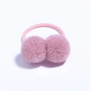 Close-up of pink fluffy pom-pom hair ties with elastic bands for girls' hairstyles