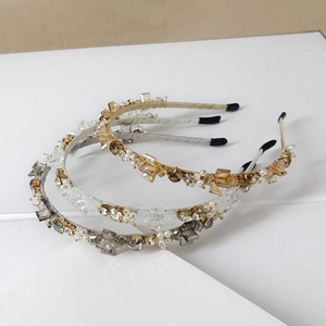 Detail view of handmade crystal headbands with square stones and white faux pearls