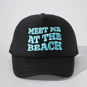 Close-up of MEET ME AT THE BEACH blue 3D embroidery on black mesh trucker hat