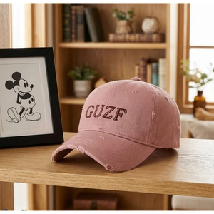 Detailed macro of vintage washed cotton cap with GUZF embroidery and distressed finish