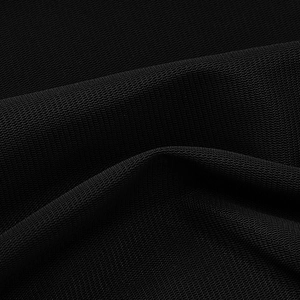 Close-up of the black sheer mesh fabric with detailed ruffle textures on a dress