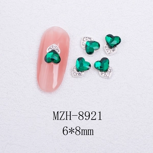 Detail of 6x8mm heart-shaped emerald cat eye nail art stones with rhinestone alloy base