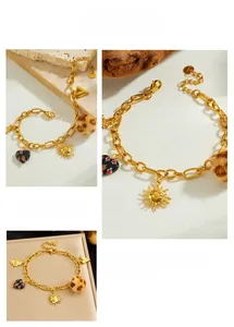 Detail of gold chain bracelet featuring leopard print ball and sun charms on stone